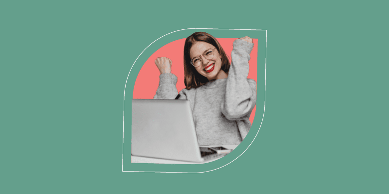 A smiling professional celebrates successful ITSM self-service, raising fists joyfully near a laptop in a vibrant setting. - SysAid